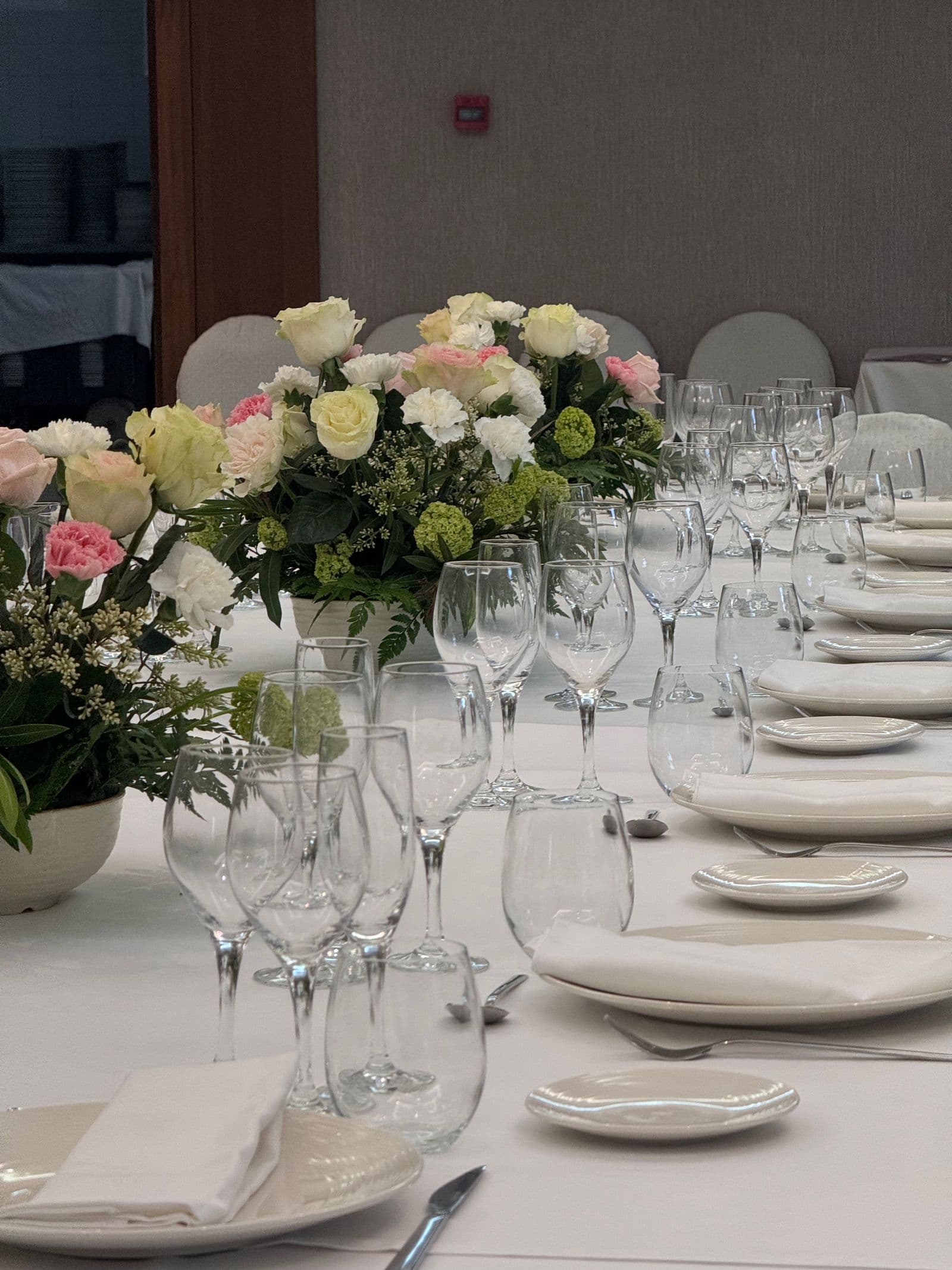 Dining tables set with glassware and flowers